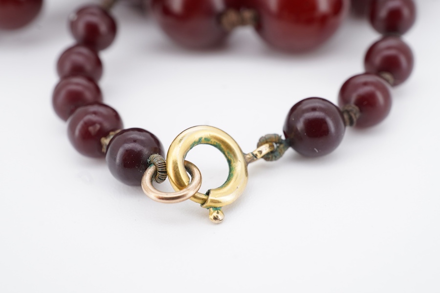 A cherry bakelite 'amber' necklace, composed of graduated spherical beads measuring approximately 6.7-23mm diameter, length approximately 86cm, gross weight 72 grams.